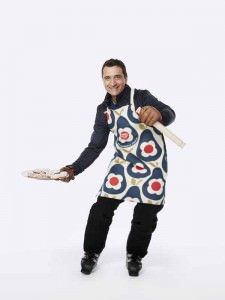 Graham Bell former Olympic skier and TV presenter, wearing the Orla Kiely Sport Relief 2016 apron available from HomeSense and TK Maxx stores